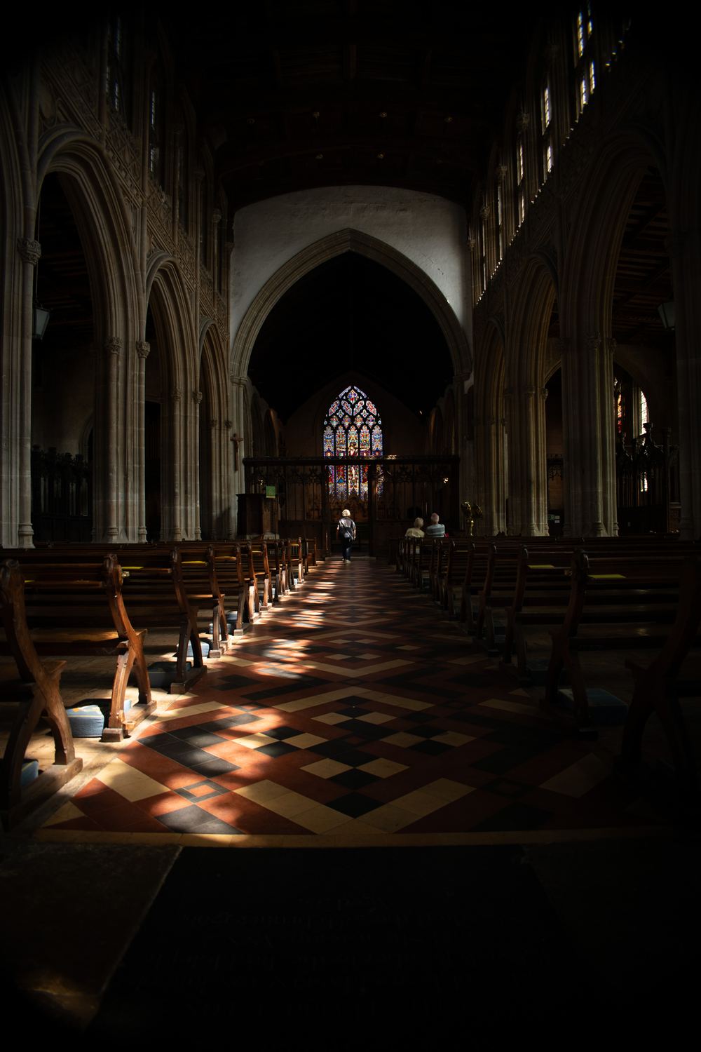 Moody church interior with light falling across the pews, Suffolk architecture photography