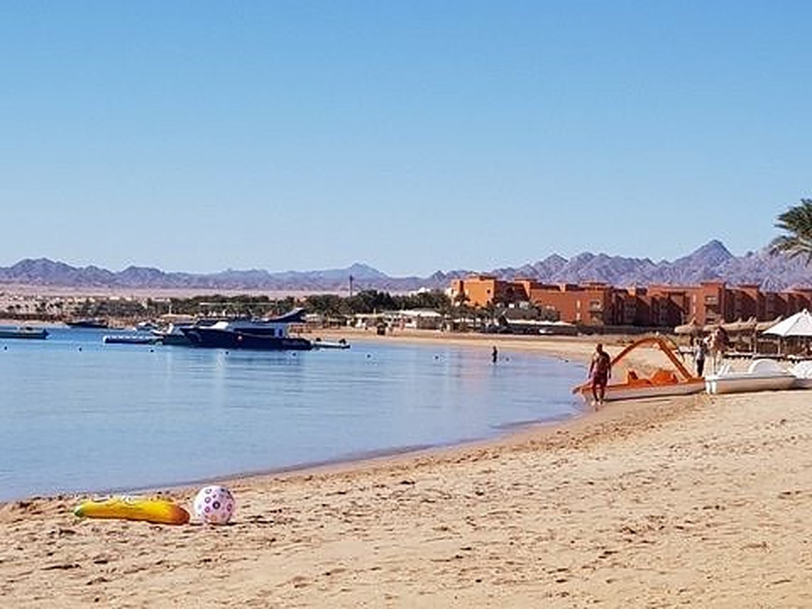 Wide coastal beach view with the sea and distant hills, landscape photography
