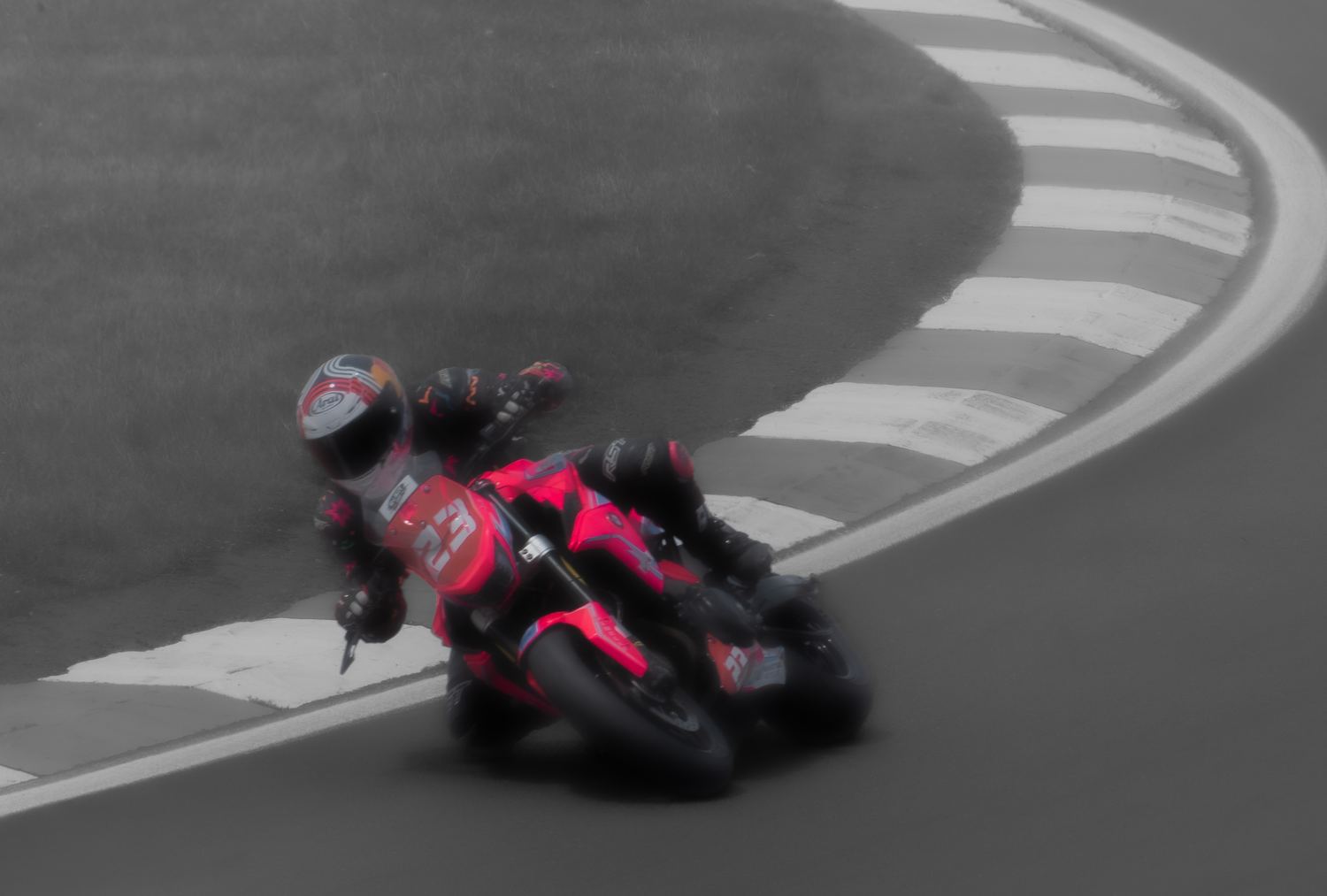 Panning motion-blur shot of a motorcycle racer cornering, motorsport photography