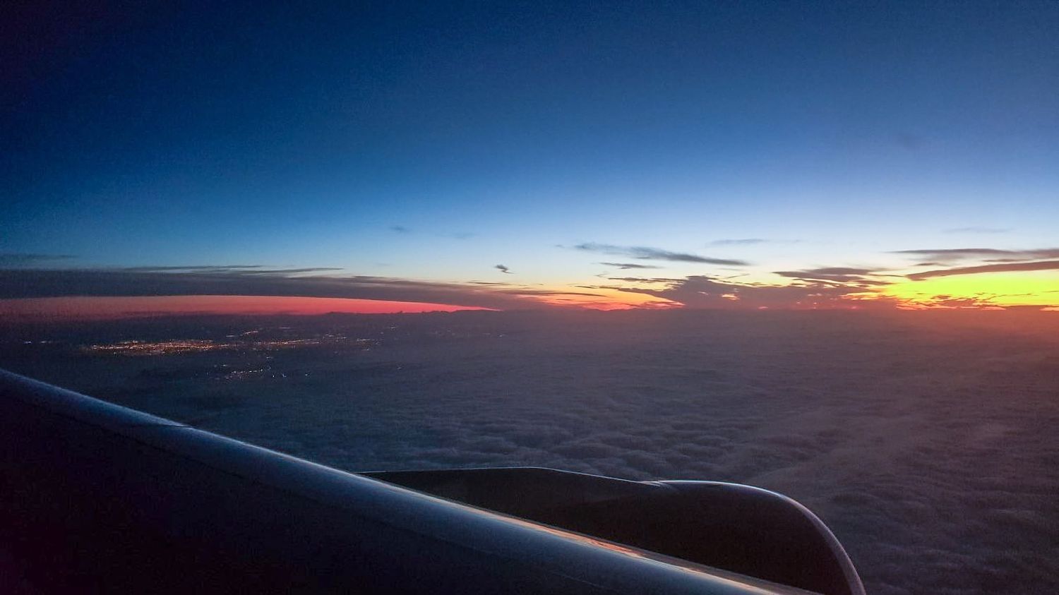 Sunset view from an aeroplane window above the clouds, landscape photography