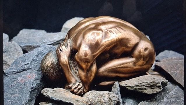 Bronze figure sculpture on rocks wall art print