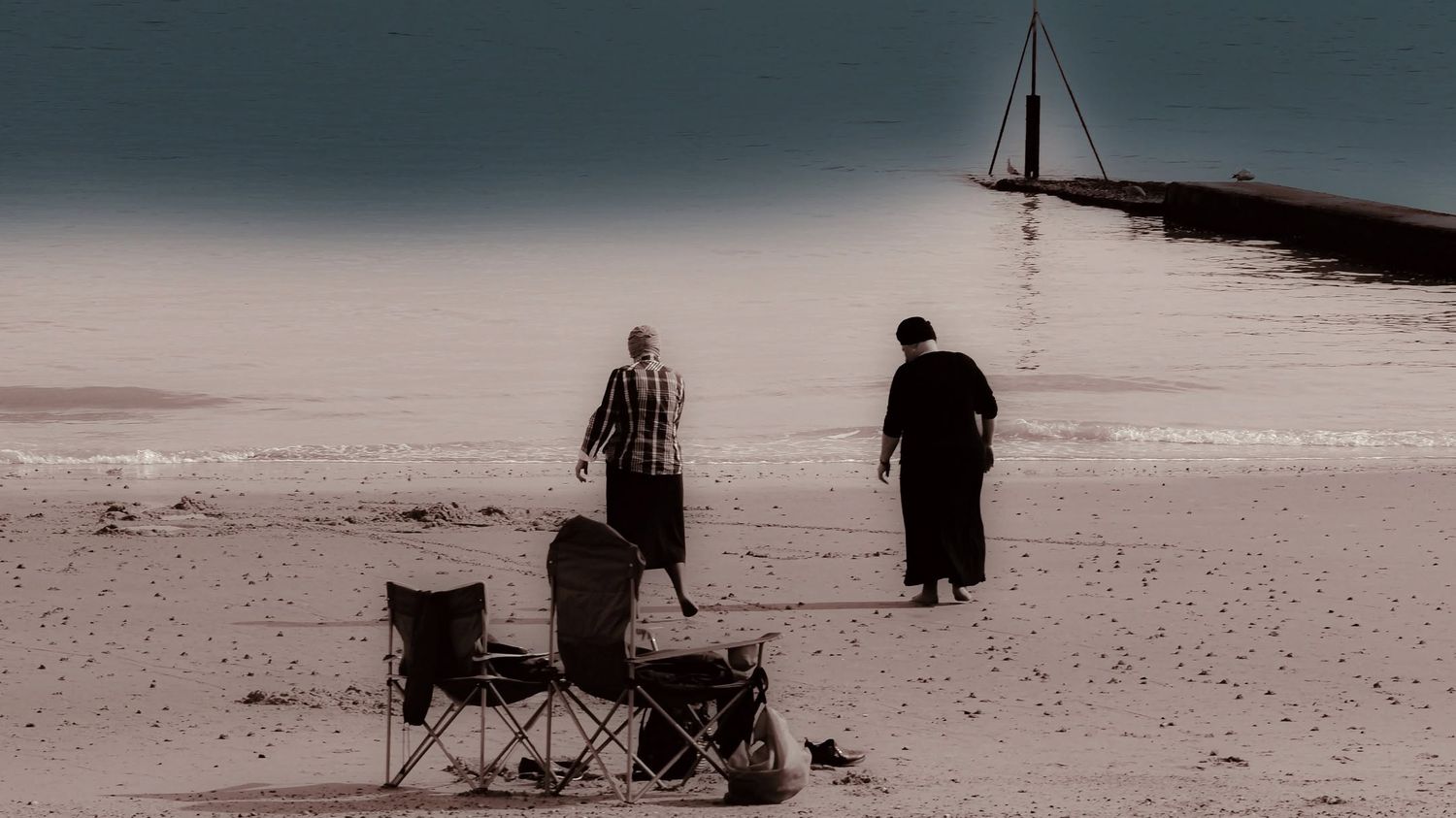 Duotone beach scene with two figures wall art print