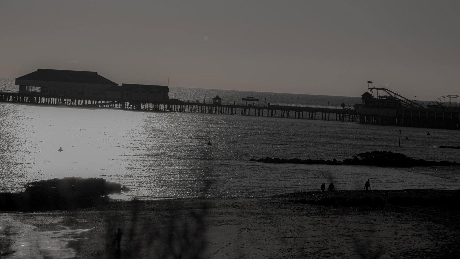 Silhouette of a seaside pier at dusk, Suffolk coast landscape photography