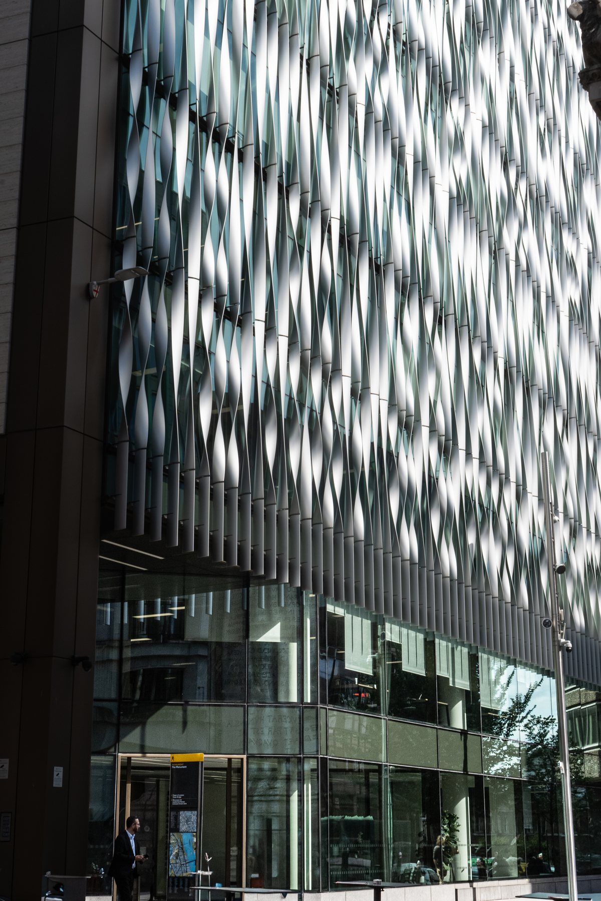 Abstract glass building facade with faceted reflections, architecture photography, London