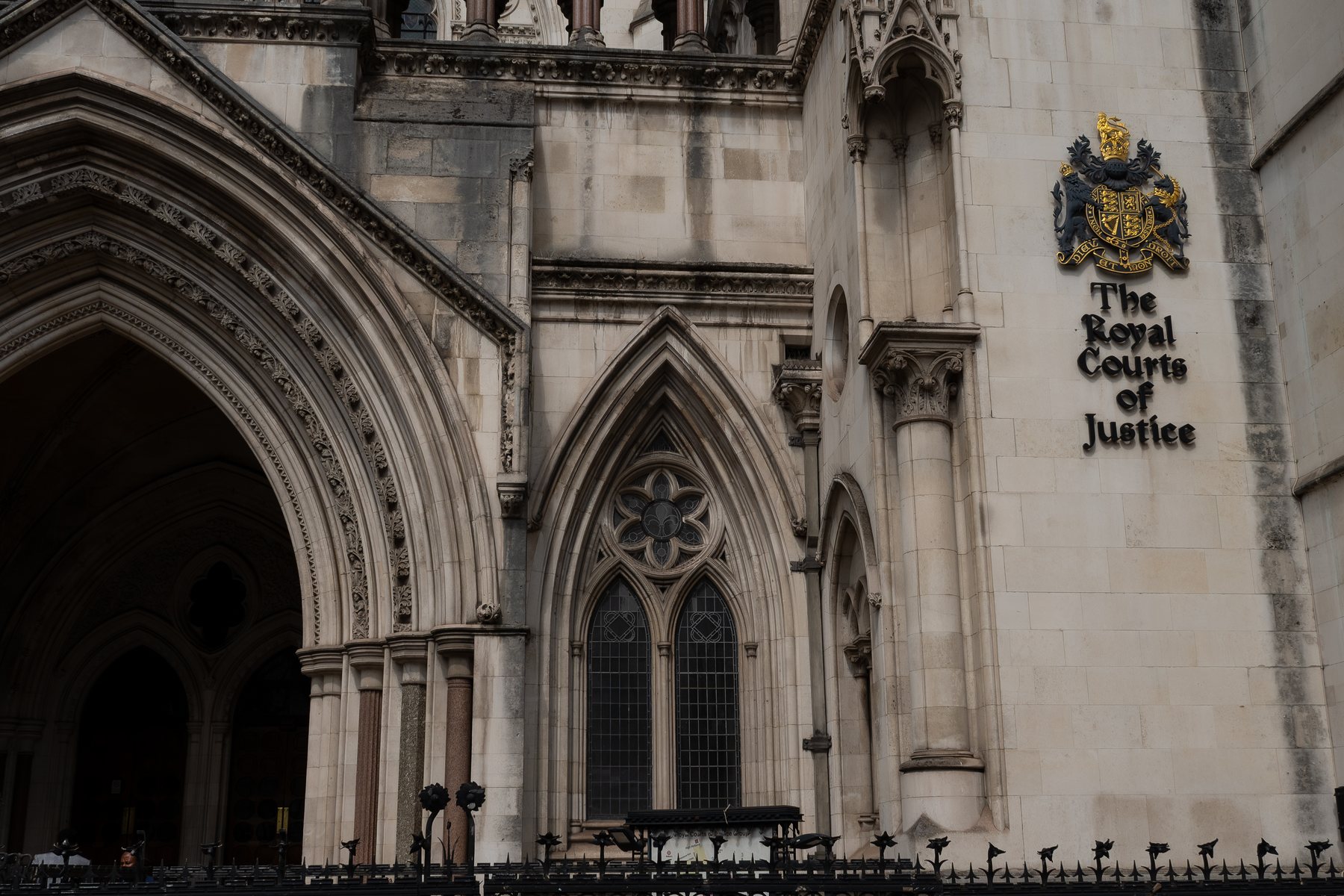 Royal Courts of Justice entrance detail with carved stonework, architecture photography, London