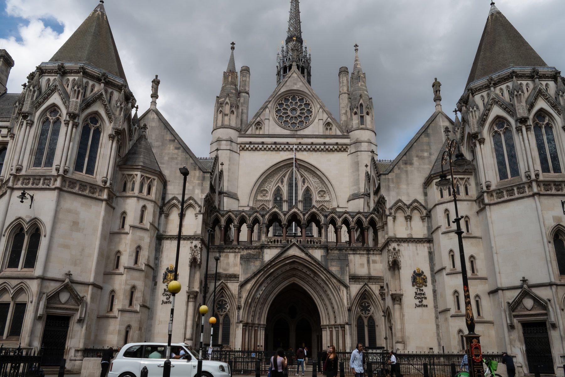 Full facade of the Royal Courts of Justice against a blue sky, architecture photography, London