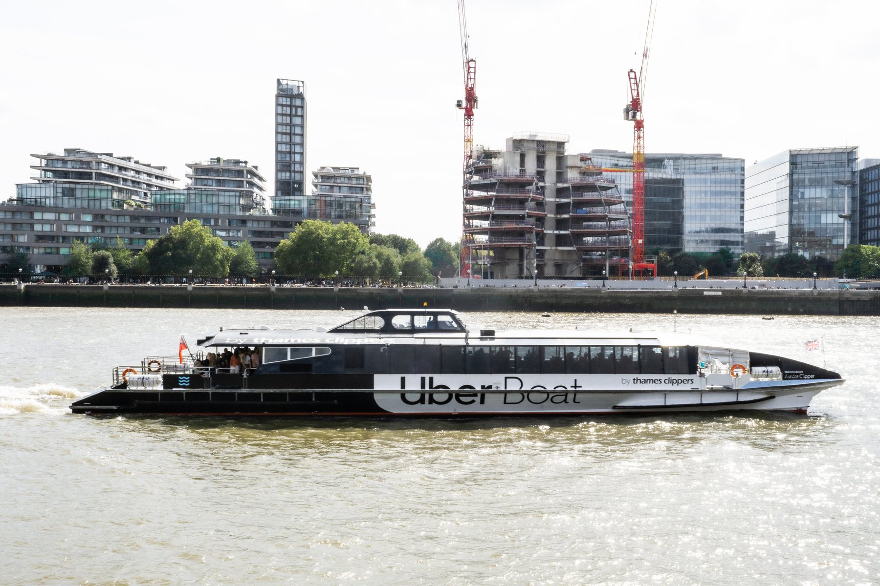 Uber Boat river bus on the River Thames with the London skyline, landscape photography