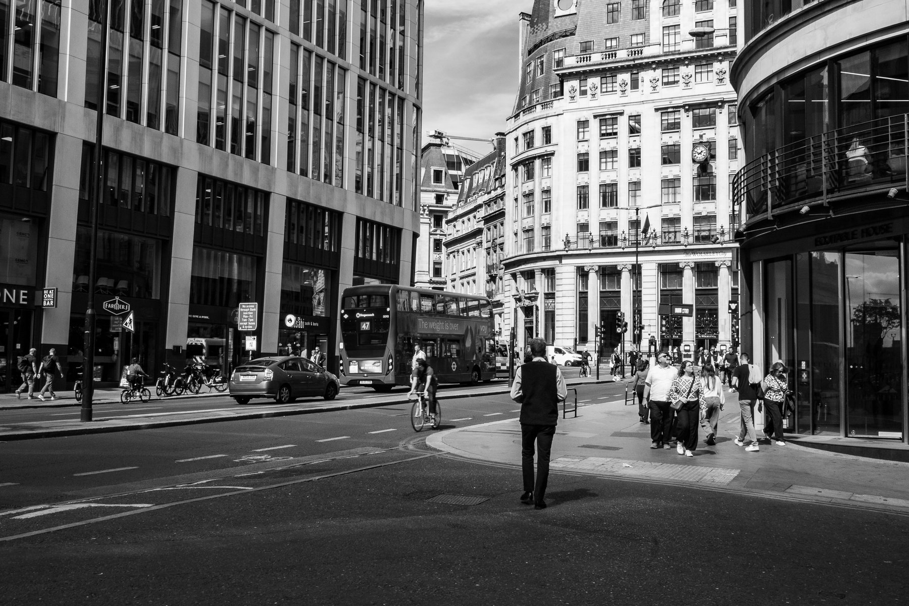 Black and white street scene with a red double-decker bus, London street photography