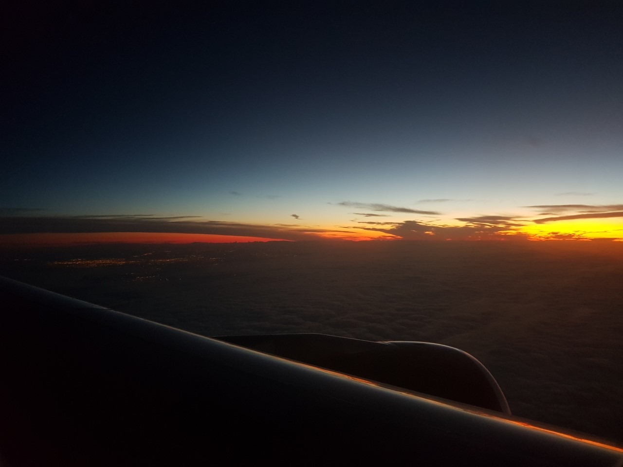Sunset over cloud cover from an aeroplane window, aerial landscape photography
