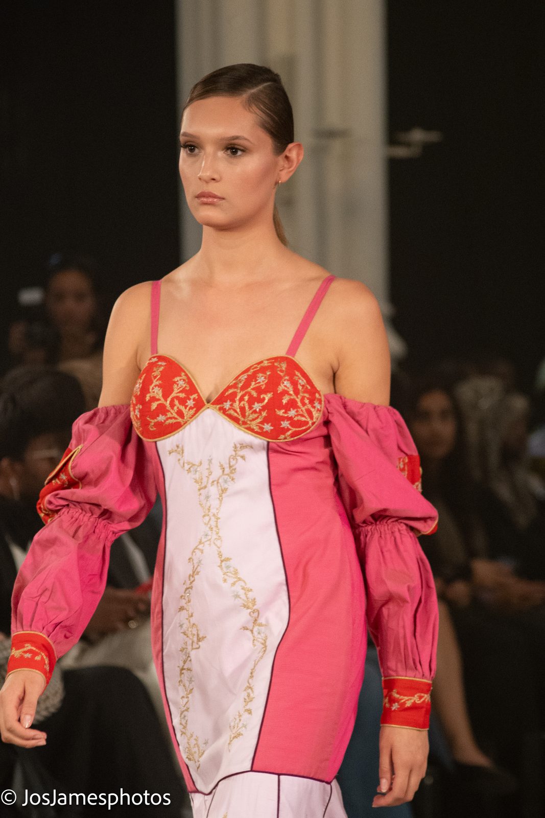 Model in a pink and red corset dress on the catwalk, London Fashion Week 2026 event photography