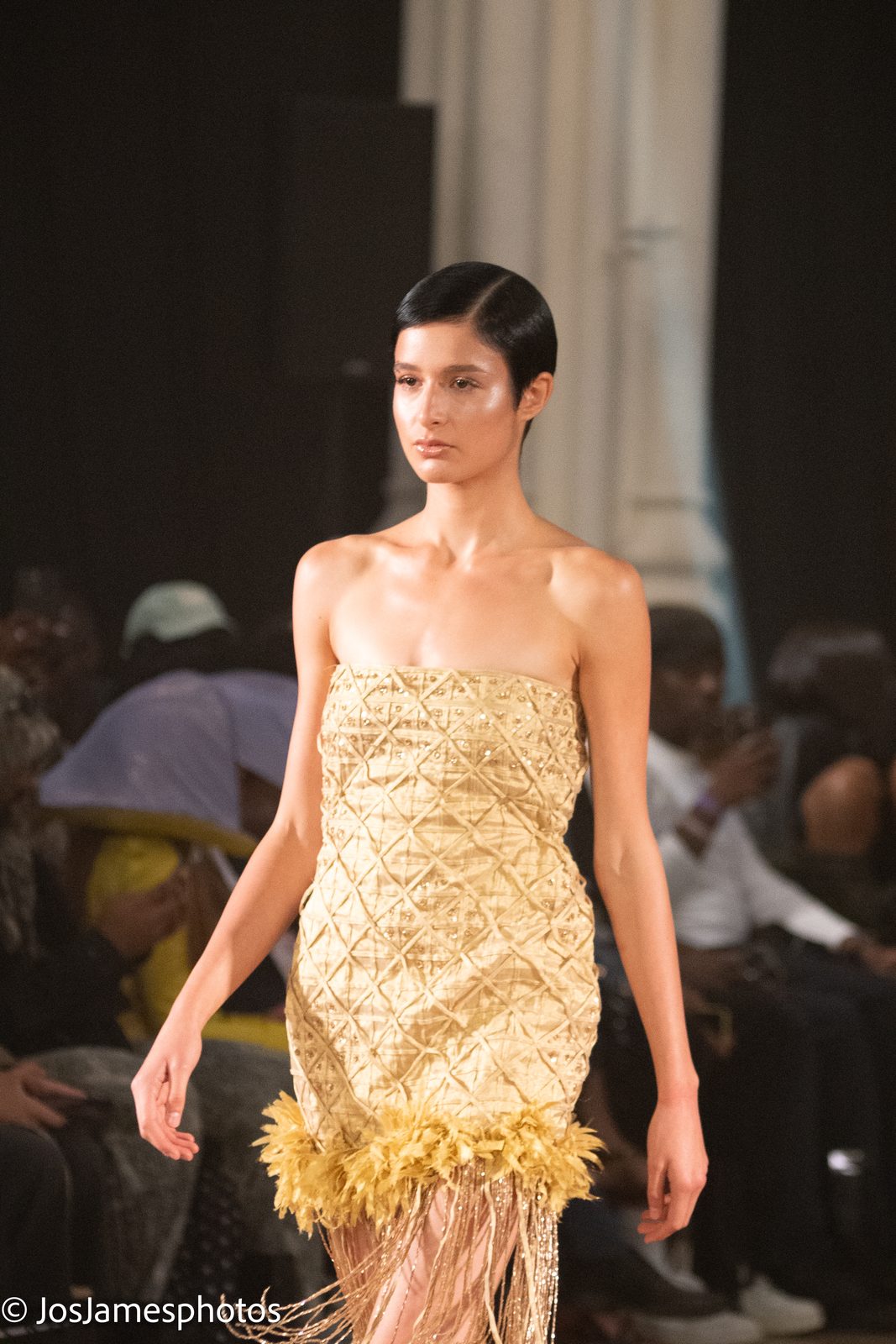 Model in a gold embellished mini dress on the catwalk, London Fashion Week 2026 event photography