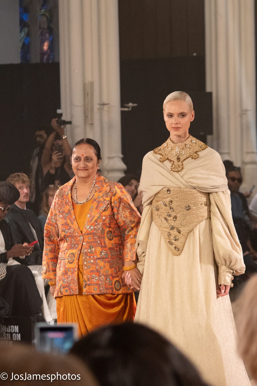 Designer walking the catwalk with her model, London Fashion Week 2026 event photography