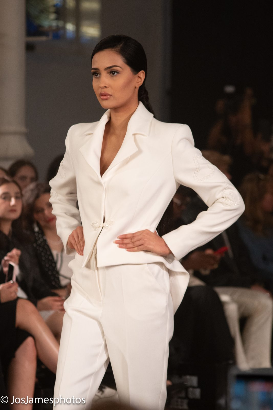 Model in a white tailored suit on the catwalk, London Fashion Week 2026 event photography