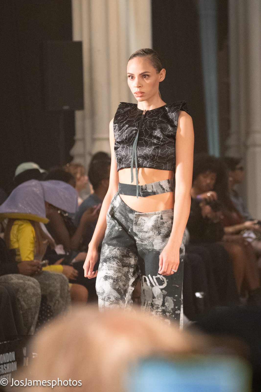 Model in a black crop top and printed trousers on the catwalk, London Fashion Week 2026
