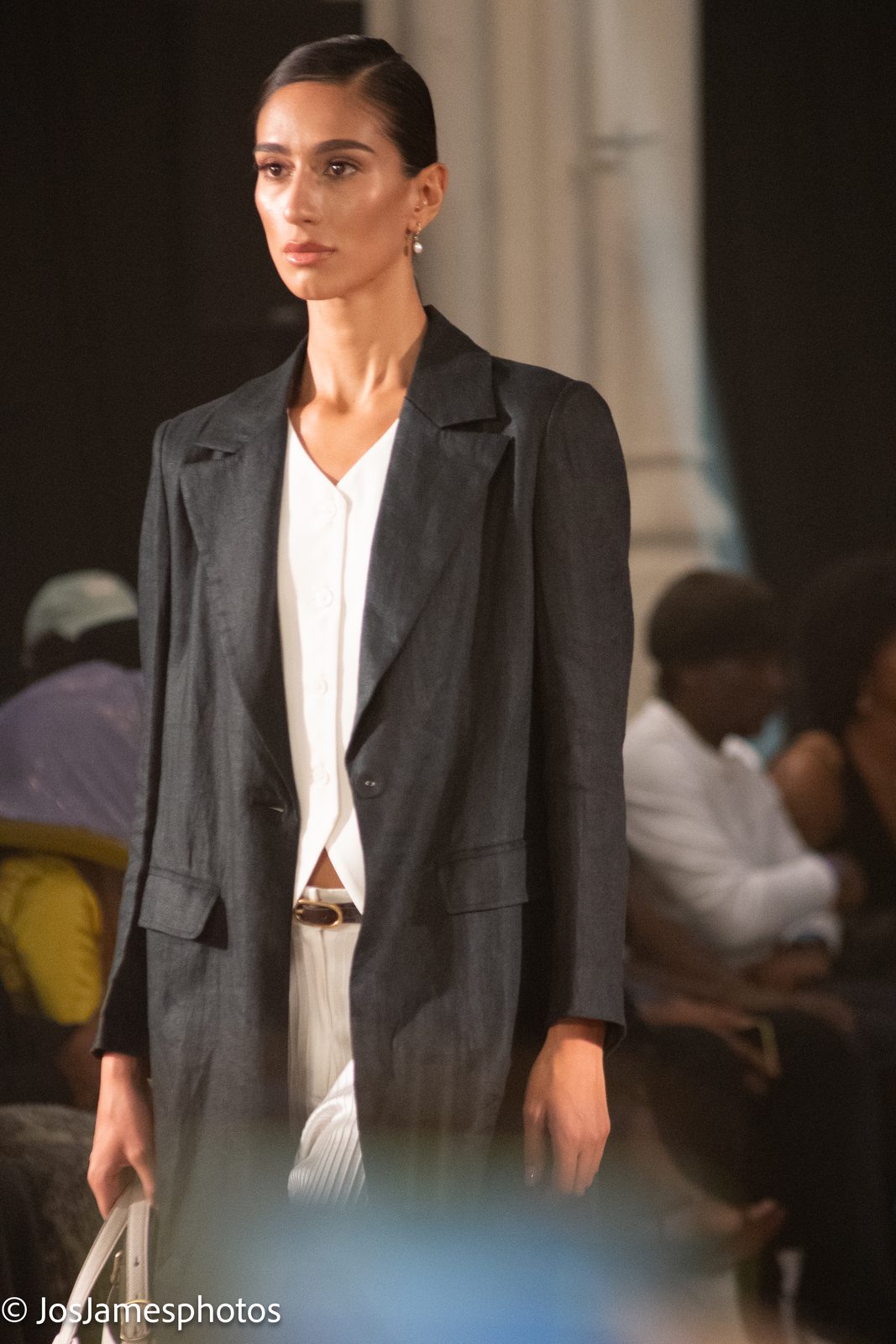 Model in a charcoal blazer and white top on the catwalk, London Fashion Week 2026 event photography