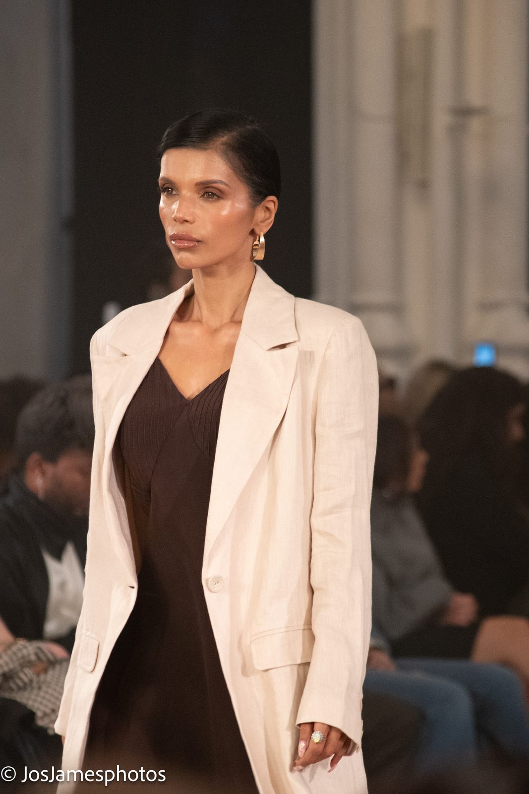 Model in a cream longline coat on the catwalk, London Fashion Week 2026