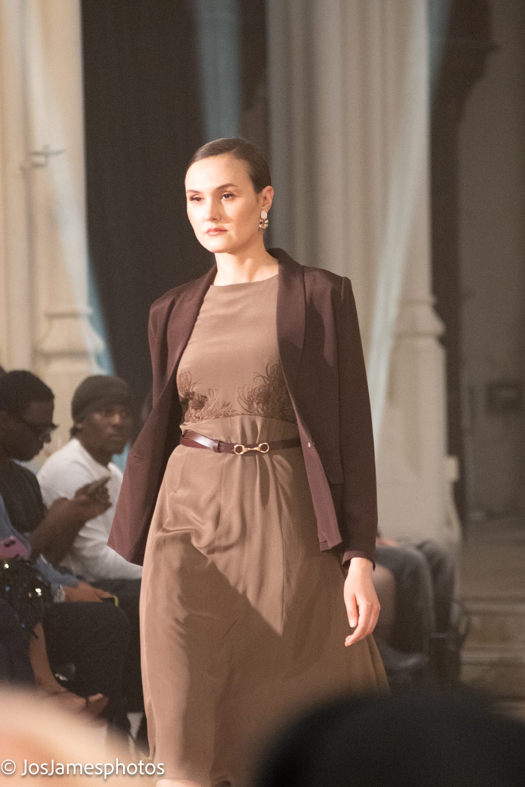Model in a taupe dress and brown blazer on the catwalk, London Fashion Week 2026