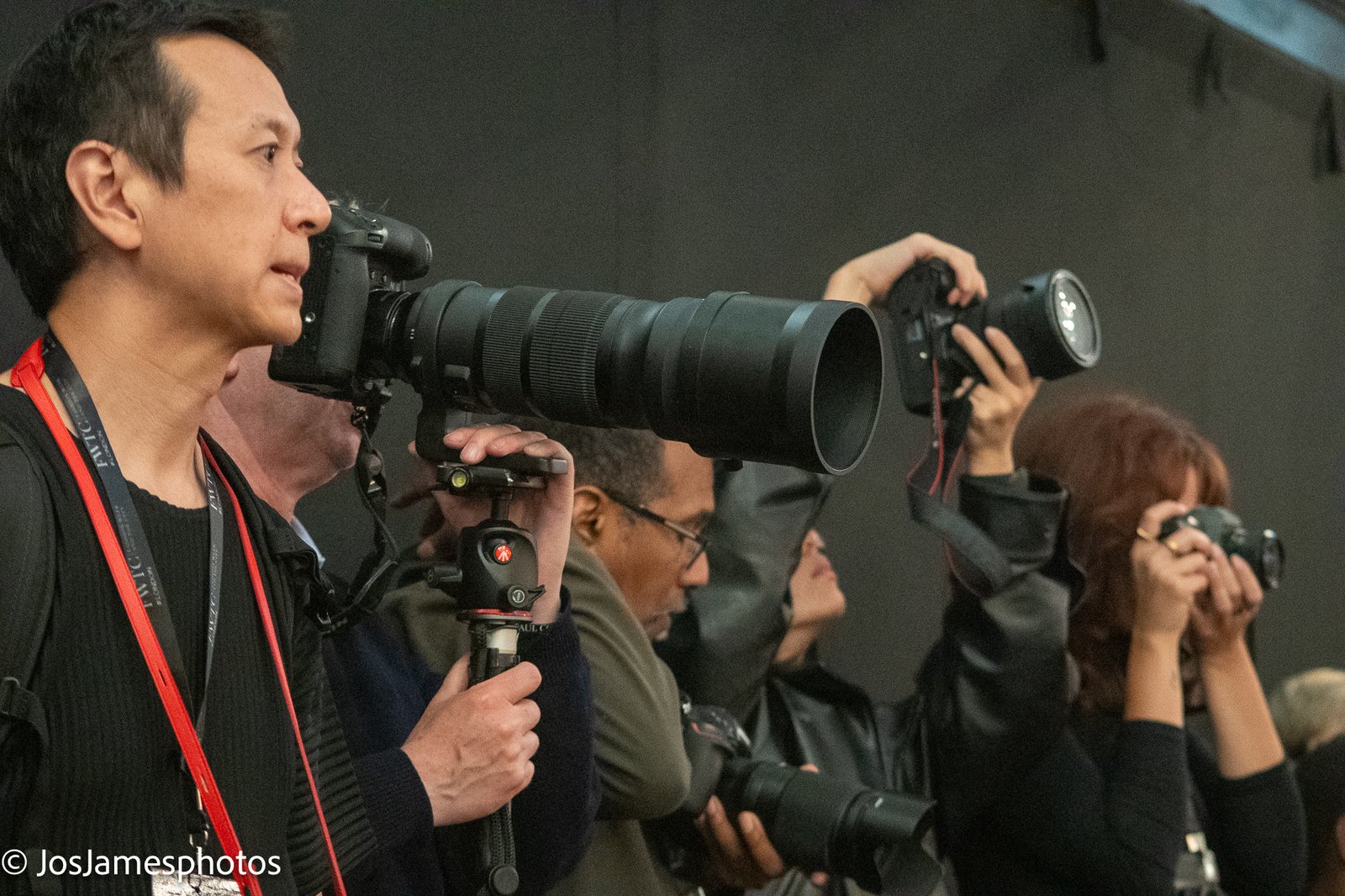 Press photographers with long lenses shooting the catwalk, London Fashion Week 2026 event photography